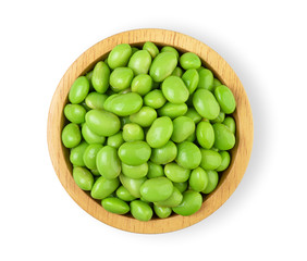 Green soy beans in a wooden cup isolated on a white background From the top view