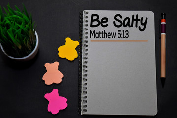 Be Salty - Matthew 5:13 write on a book isolated on office desk. Christian faith concept