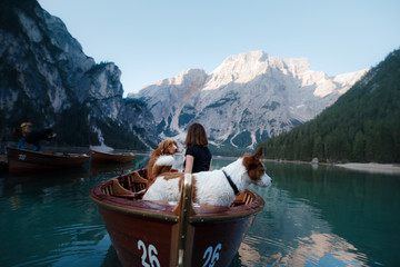 women and dog in a boat on a mountain lake. Traveling with a pet to Italy. girl with Dog