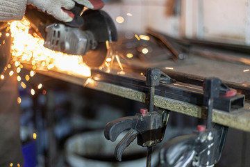 Metal cutting. Grinding steel. Work as a grinder. Sparks from friction. Men's work. Creating a...