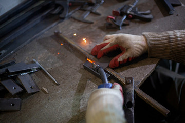 Metal welding. Sparks from electric heating. Work in the workshop. Creation of reliable fastening...