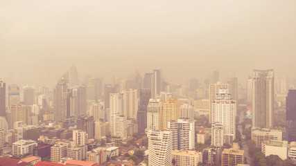 Fototapeta na wymiar cityscape of high rise buildings in poor weather morning, haze of pollution covers city, global warming concept, pm2 5 air pollution
