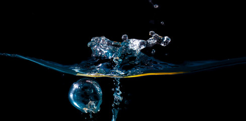 water waves with beautiful bubbles on a black background.
