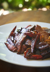 Asian style food dish noodle with vegetables and meat close up on the table