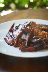 Asian style food dish noodle with vegetables and meat close up on the table
