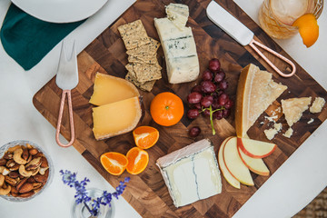 Cheese board with assorted cheeses, crackers and fruit 