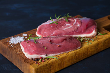 Raw fresh meat, duck breast fillet on wood chopping board