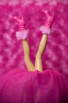 WOODBRIDGE, NEW JERSEY - May 10, 2019: A Barbie Doll does a handstand to show off her pink high-heeled boots with furry cuffs