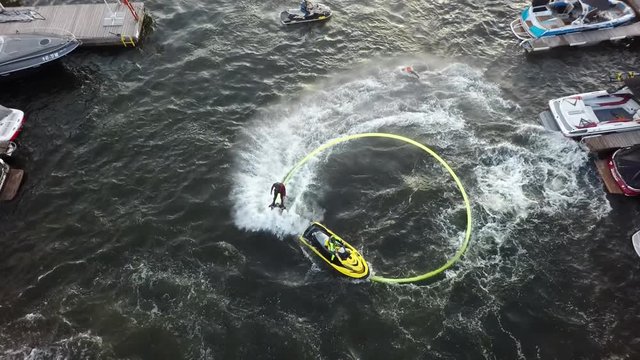 MOSCOW, RUSSIA - AUGUST 17, 2019: Aerial shot of three water jet flyboard riders giving a performance in river quay and doing tricks