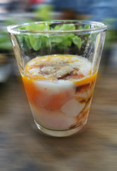 Soft-boiled egg, add soy sauce and pepper in a glass