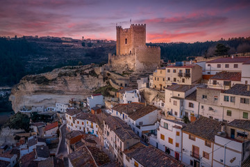 Sunset aerial panorama view of Alcala del Jucar medieval historic village with white washed houses...