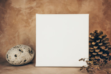 White canvas board in interior. Blank space for art picture or photo. Canvas printing concept. Mockup poster.