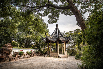 A small gazebo at Wuyuan Gardens in China gives tourists palace to rest while visiting the Gardens