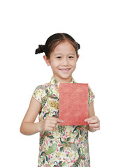 Happy little Asian girl wearing cheongsam smiling and holding red envelope isolated on white background. Happy Chinese New Year.