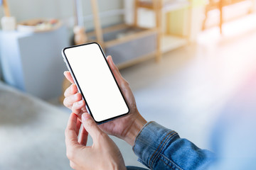 Mockup image blank white screen cell phone.man hand holding texting using mobile on desk at coffee shop.background empty space for advertise text.people contact marketing business,technology 