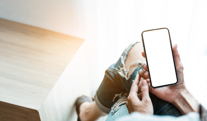 Mockup image blank white screen cell phone.man hand holding texting using mobile on desk at coffee shop.background empty space for advertise text.people contact marketing business,technology 
