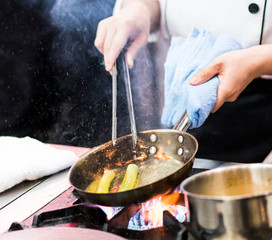 Chef cooking, Chef preparing food in the kitchen, Chef decorating dish, closeup.