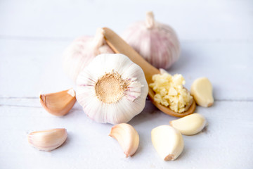 Garlic, fresh sliced garlic  isolated on white wooden background.