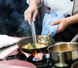 Chef cooking, Chef preparing food in the kitchen, Chef decorating dish, closeup.