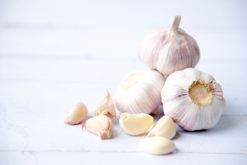 Garlic, fresh sliced garlic  isolated on white wooden background.
