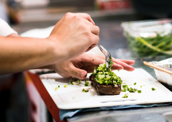 Chef cooking, Chef preparing food in the kitchen, Chef decorating dish, closeup.