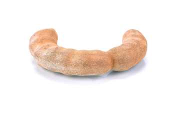 Sweet tamarind isolated on white background. One fresh whole tamarinds.