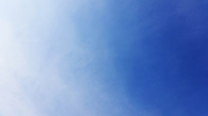 Deep blue sky picture shot with interweaving clouds. Plane blue space with just a interweave cloud to be used being a backing in your work  area. Royalty free stock picture.