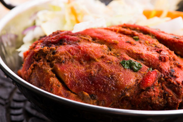 Close-up of a plate of chopped tandoori chicken