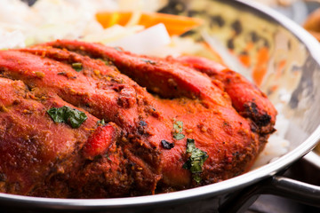Close-up of a plate of chopped tandoori chicken