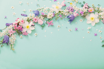 beautiful spring flowers on green paper background