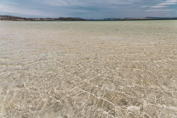 view of Dunalley Beach in Tasmania, Australia with sandbanks and shallow pristine water