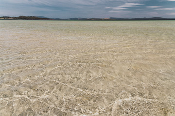 view of Dunalley Beach in Tasmania, Australia with sandbanks and shallow pristine water