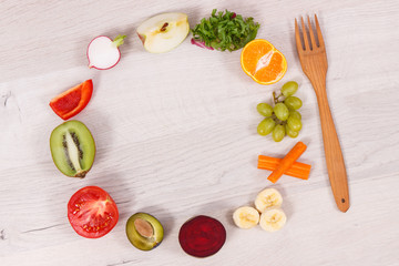 Fresh fruits and vegetables with wooden fork, concept of food containing natural vitamins