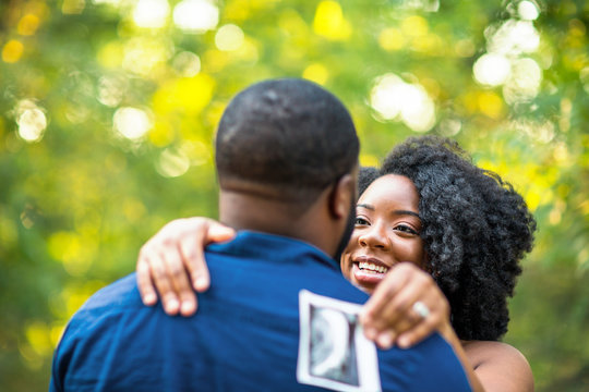 Portrait of a happy pregnant African American couple.
