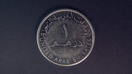  One UAE dirham isolated on black background, macro shot of United Arab Emirates one dirham isolated .