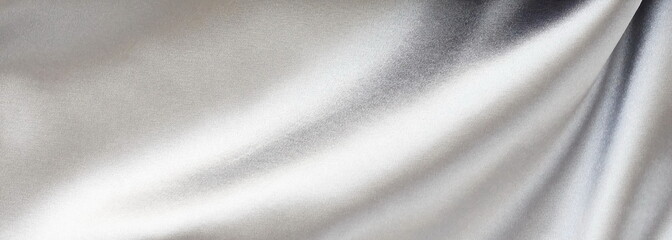 Silk fabric texture pastel silver color banner background. Beautiful soft crumpled silk wedding background.Copy space