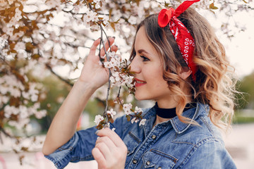 Fototapeta premium Beautiful girl in a blue blouse. Woman in a summer park