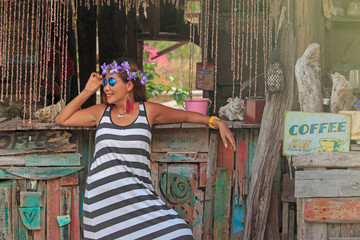 Thai girls relax and have fun, wood house backdrop on the beach, Ko Phayam, Thailand