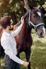 Obraz premium Horse theme. Businessman with a horse. Man in a suit