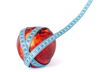 Diet concept with red apple and measure tape