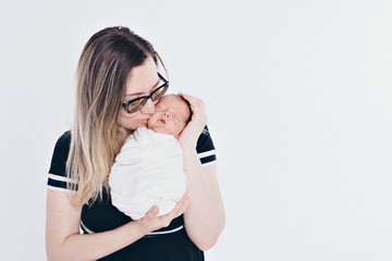 the concept of a healthy lifestyle, the protection of children, shopping - baby in the arms of the mother. Woman holding a child. Isolated on white background. Copy space