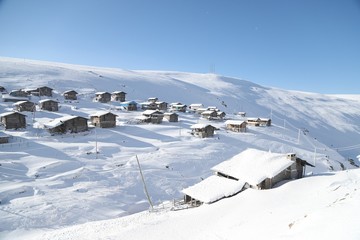 mountain landscape slopes covered with snow can be seen a tree fence and a house.savsat/artvin