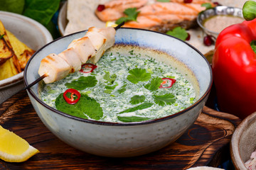 Cold soup okroshka with matzoon chicken and coriander served in a bowl with vegetables. Traditional georgian cuisine