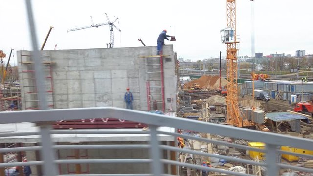 The view from the train window. Moscow Central Circle, urban rail transport. The train passes the construction site