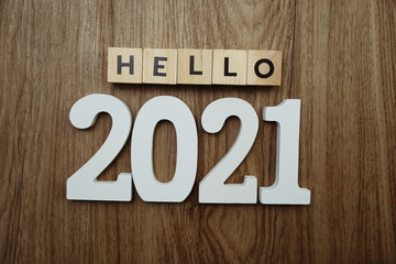 Hello 2021 word alphabet letters on wooden background