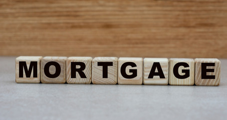 Fototapeta na wymiar concept of the word mortgage on cubes on a wooden background