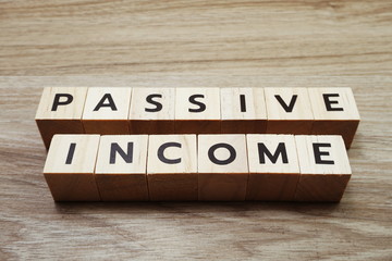 Passive Income alphabet letters on wooden background