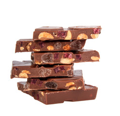 milk chocolate with nuts and berries brocken isolated on the white