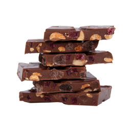 milk chocolate with nuts and berries brocken isolated on the white