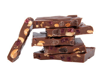 milk chocolate with nuts and berries brocken isolated on the white